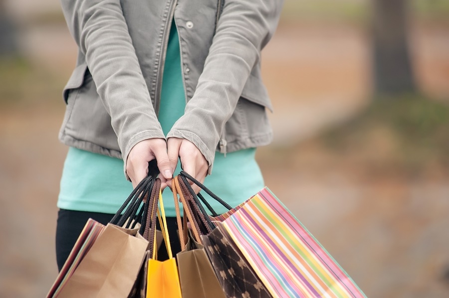 A woman with multiple shopping bags | closeup images.